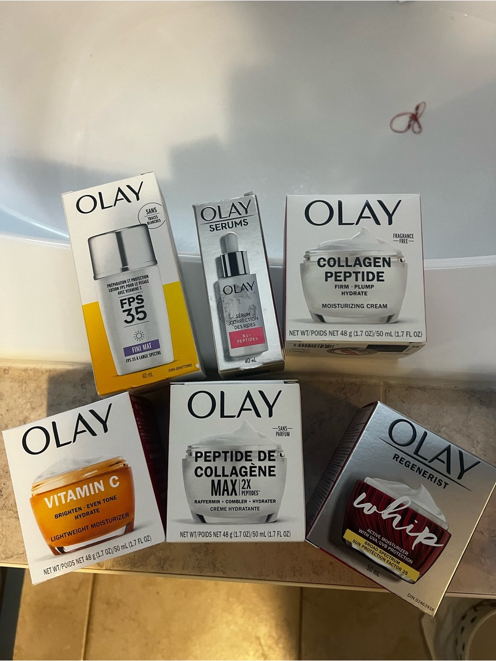 OLAY Skincare Set with White, Orange, Yellow and Silver Packaging
